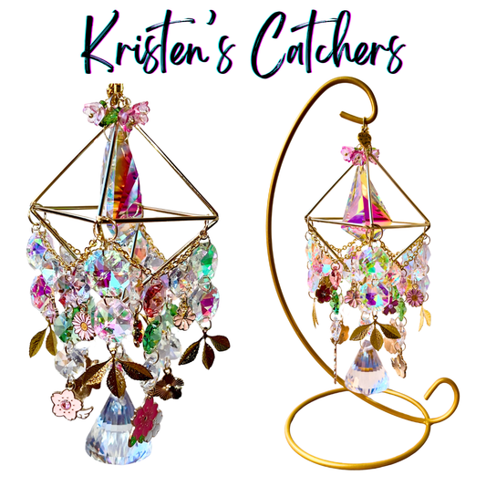 Handcrafted gold 3D geometric desk sun catcher with 16 flower charms, gold leaf accents, iridescent A/B crystals, and a teardrop pendant. Includes gold display stand.