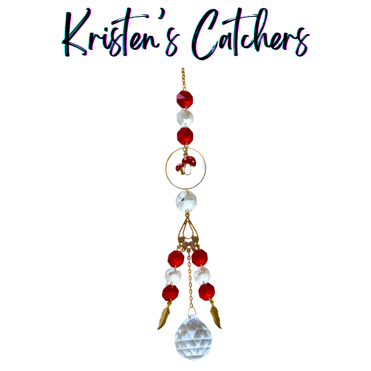 Crimson Forest Journey Sun Catcher with red mushroom charm, gold feather accents, ruby and crystal prisms, and faceted crystal ball pendant hanging against white background