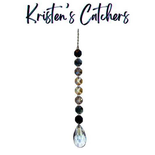 Handcrafted single strand black gradient sun catcher with bronze hardware flowing from deep black through champagne gold to a clear iridescent teardrop pendant drop.