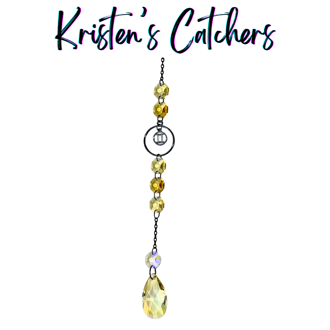 Gemini zodiac sun catcher with gunmetal twins symbol centerpiece featuring yellow and champagne crystals with black chain