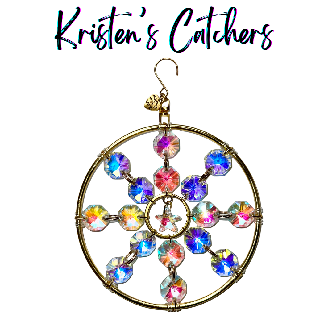 Gold-framed sun catcher with star centerpiece and aurora crystals creating prismatic light displays