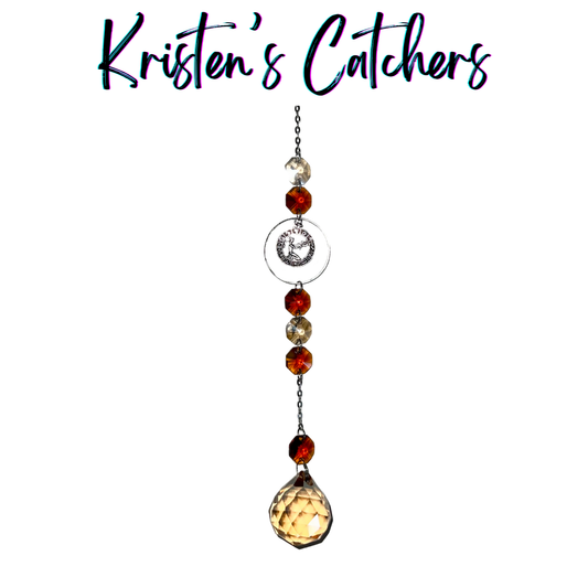 Silver Virgo sun catcher with ruby crystals and amber teardrop creating precise light patterns