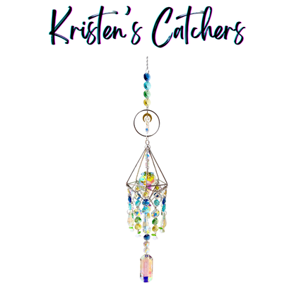 Handcrafted 3D geometric sun catcher with wire diamond frame, floral charms, crescent moon accent, gradient blue-to-yellow bead header, cascading iridescent crystals in blue green yellow and pink, and a large rectangular pendant drop