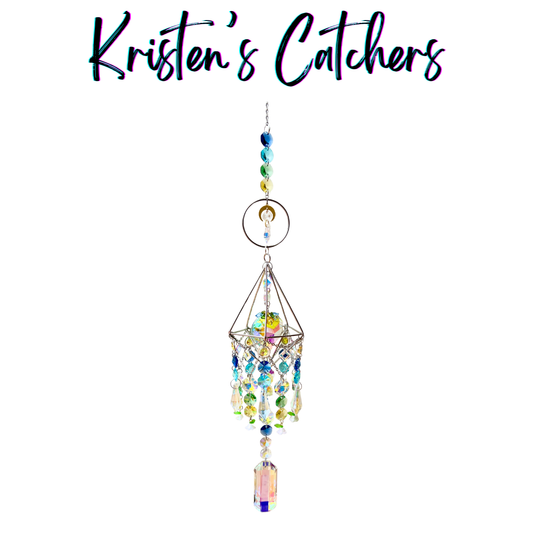 Handcrafted 3D geometric sun catcher with wire diamond frame, floral charms, crescent moon accent, gradient blue-to-yellow bead header, cascading iridescent crystals in blue green yellow and pink, and a large rectangular pendant drop