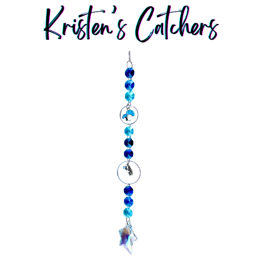 Handcrafted single strand sun catcher with silver astronaut charm, blue mushroom charm, deep royal and teal blue faceted beads, and an iridescent A/B star-shaped pendant drop