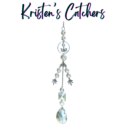 Handcrafted single strand sun catcher with silver lotus charm, om symbol connector, three silver botanical leaf charms, clear faceted beads, stacked clear crystals, and a large A/B teardrop pendant drop