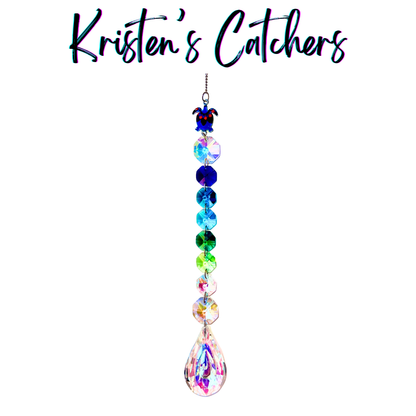 Handcrafted single strand sun catcher with blue enamel sea turtle charm, full blue-to-green gradient bead strand, and a large iridescent A/B teardrop pendant drop.