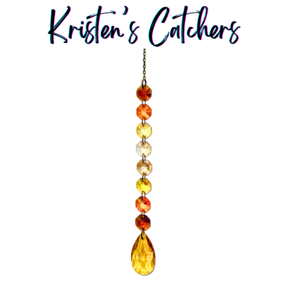 Handcrafted single strand warm gradient sun catcher with bronze hardware flowing from burnt orange through amber and champagne to a rich amber-gold teardrop pendant drop.
