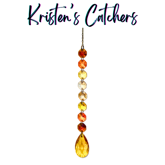 Handcrafted single strand warm gradient sun catcher with bronze hardware flowing from burnt orange through amber and champagne to a rich amber-gold teardrop pendant drop.