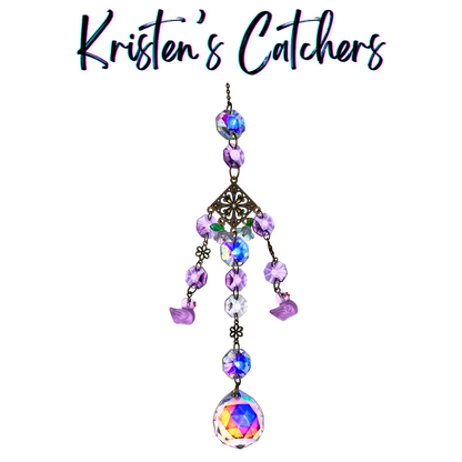 Lavender and iridescent crystal sun catcher with vintage filigree design, purple bird charms, and rainbow crystal ball