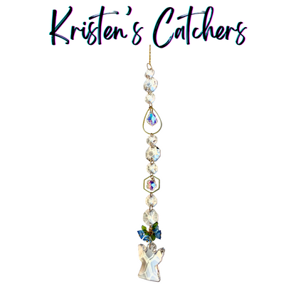 Heavenly angel sun catcher with small angel centerpiece, blue flower accents, and clear prisms hanging against white background