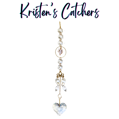 Handcrafted white cat crystal sun catcher with clear beads, golden accents, and heart pendant, made in Venice Beach