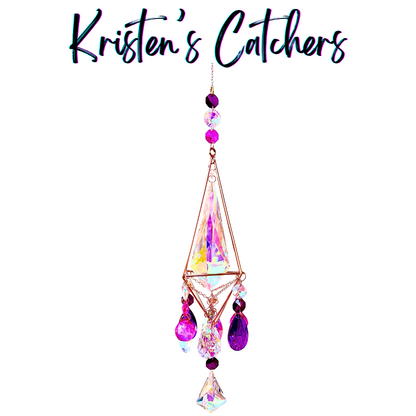 Rose gold 3D geometric sun catcher with triangular frame featuring extra-large A/B center crystal and cascading purple magenta prism party