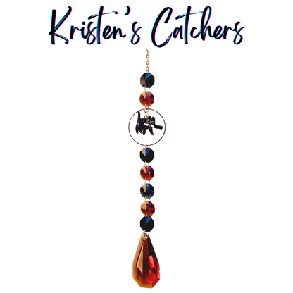 Tortie Attitude Killer Cats sun catcher with tortoiseshell cat centerpiece featuring alternating amber and black crystals with large amber teardrop