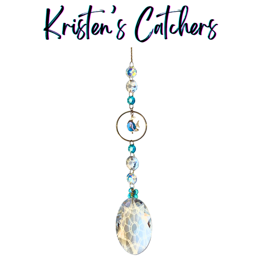 Hawaiian island vibes sun catcher with dolphin charm and extra-large prism creating rainbow displays with ocean blue crystals