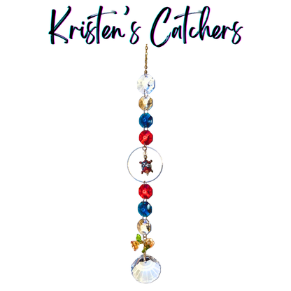 Hawaiian sea turtle sun catcher with honu charm featuring coral red, ocean blue and gold crystals with shell-shaped prism