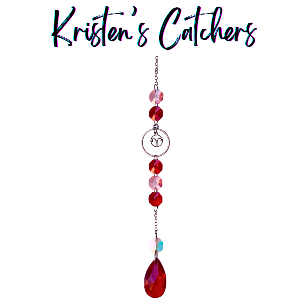 Aries zodiac sun catcher with ram symbol centerpiece featuring red and pink crystals with rose gold hardware