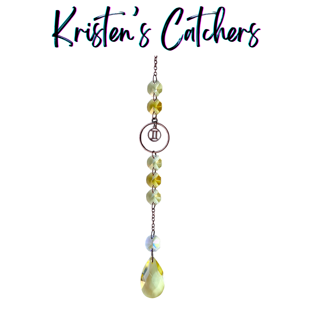 Gemini zodiac sun catcher with twins symbol centerpiece featuring yellow and champagne crystals with rose gold hardware