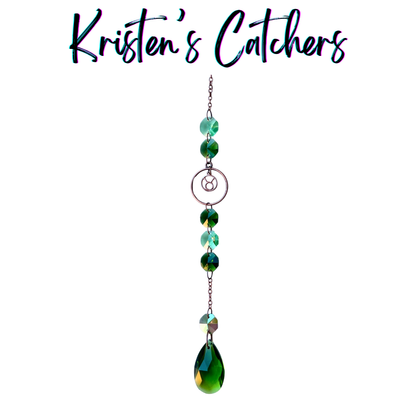 Taurus zodiac sun catcher with bull symbol centerpiece featuring green and teal crystals with rose gold hardware