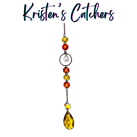 Leo zodiac sun catcher with lion symbol centerpiece featuring yellow and red crystals with rose gold hardware