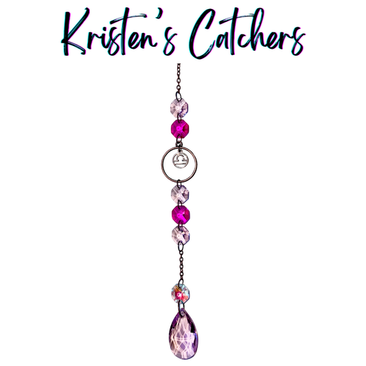 Libra zodiac sun catcher with scales symbol centerpiece featuring pink and magenta crystals with rose gold hardware