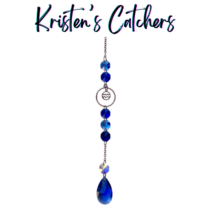 Aquarius zodiac sun catcher with water bearer symbol centerpiece featuring electric blue crystals with rose gold hardware