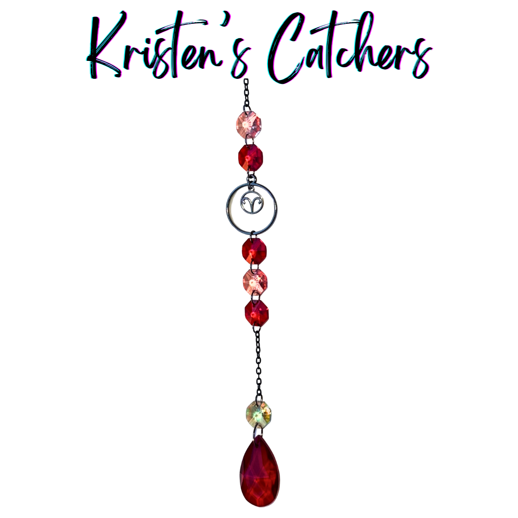 Aries zodiac sun catcher with gunmetal ram symbol centerpiece featuring red and pink crystals with black chain