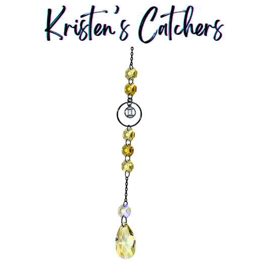 Gemini zodiac sun catcher with gunmetal twins symbol centerpiece featuring yellow and champagne crystals with black chain