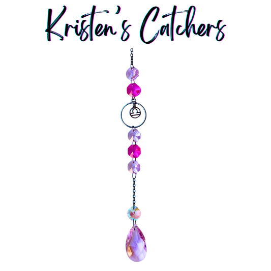 Libra zodiac sun catcher with gunmetal scales symbol centerpiece featuring pink and magenta crystals with black chain