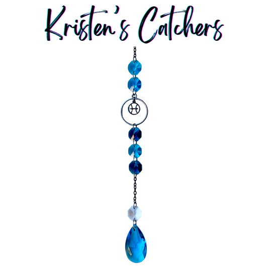 Pisces zodiac sun catcher with gunmetal fish symbol centerpiece featuring ocean blue and teal crystals with black chain
