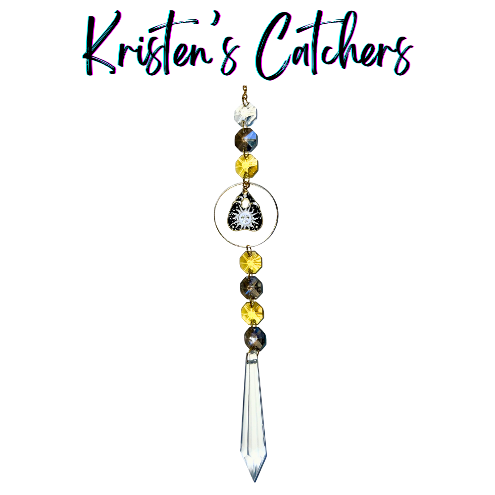 Celestial Halloween Sun Catcher with black and gold sun pendant, yellow and gray crystals, and clear crystal spear