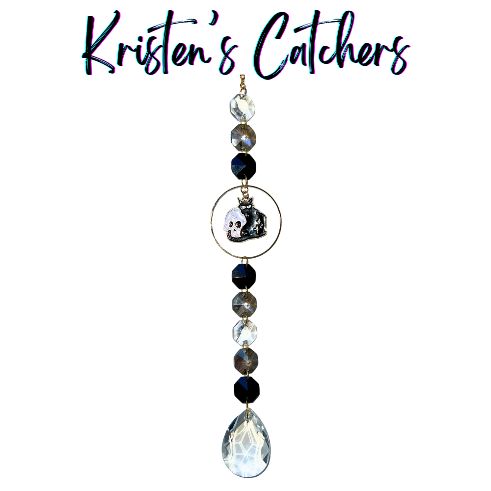 Halloween Cat Cuddling Skull Sun Catcher with black, gray, and clear crystals and a clear drop pendant