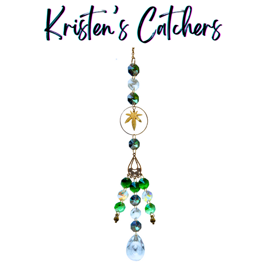 Handmade gold leaf sun catcher with emerald and aurora borealis glass creating luxe bohemian reflections