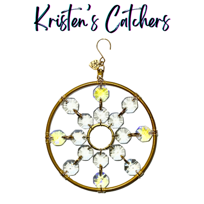 Ornamental snowflake sun catcher with gold and violet aurora borealis accents