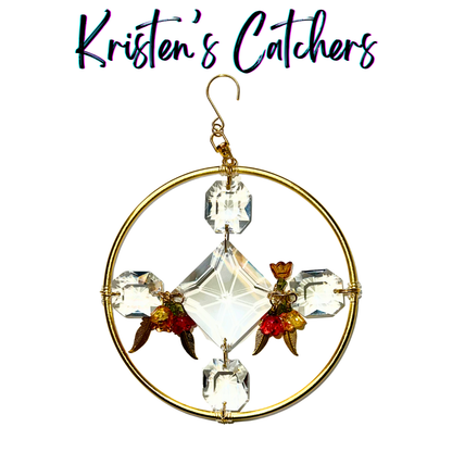 Ornamental sun catcher with golden feathers and red floral accents