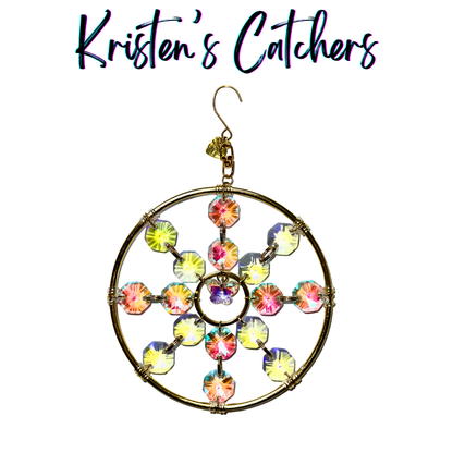 Ornamental sun catcher with butterfly centerpiece and golden-pink aurora borealis accents