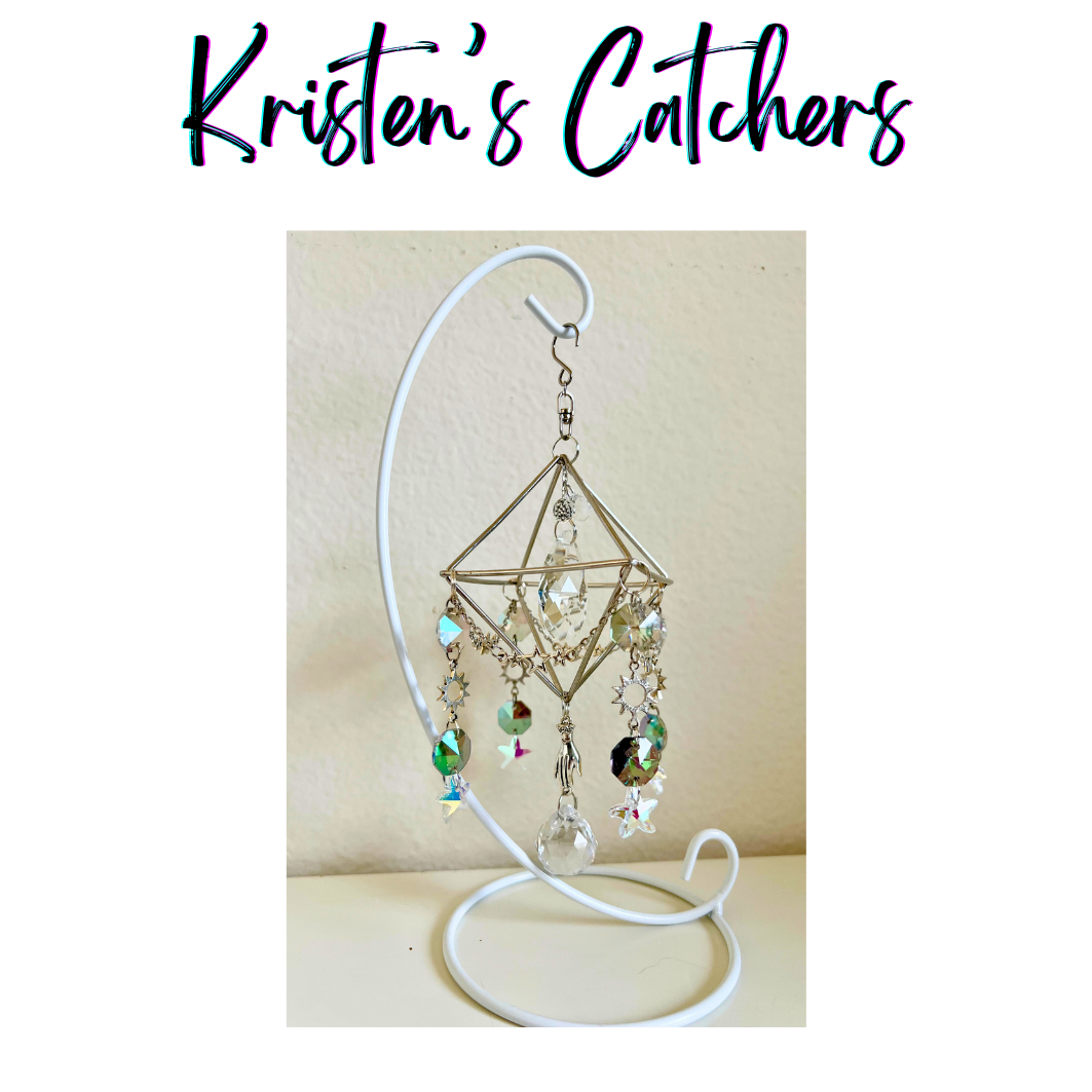 Geometric tabletop sun catcher with silver cube frame and celestial crystal design