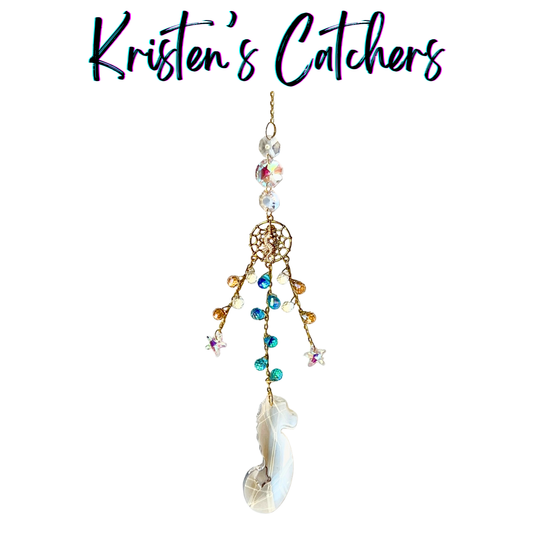 Handcrafted sun catcher with large iridescent seahorse prism pendant, gold woven net connector with seahorse charm, cascading teal amber and iridescent micro crystal fringe, A/B star charms, and large shifting iridescent header beads