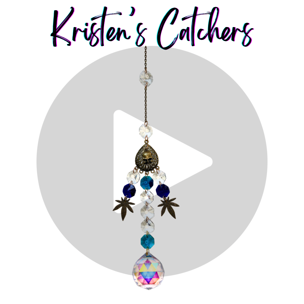 Blazing Buds sun catcher with A/B coated and dark blue crystals, bronze weed leaf and a skull charms.