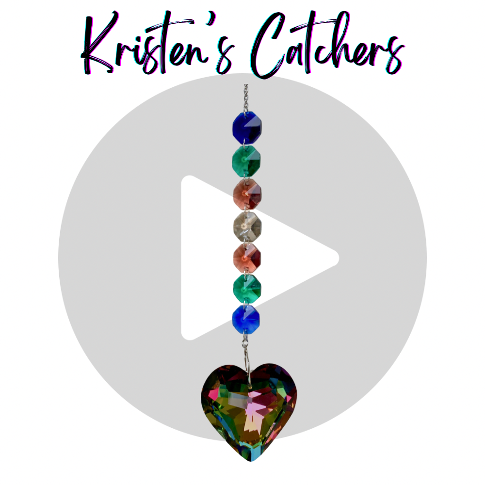 Heart of the Ocean sun catcher with a heart-shaped crystal and blue, green, and amber crystals