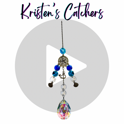 Cosmic Charm sun catcher with A/B coated and blue crystals, celestial-themed bronze charms